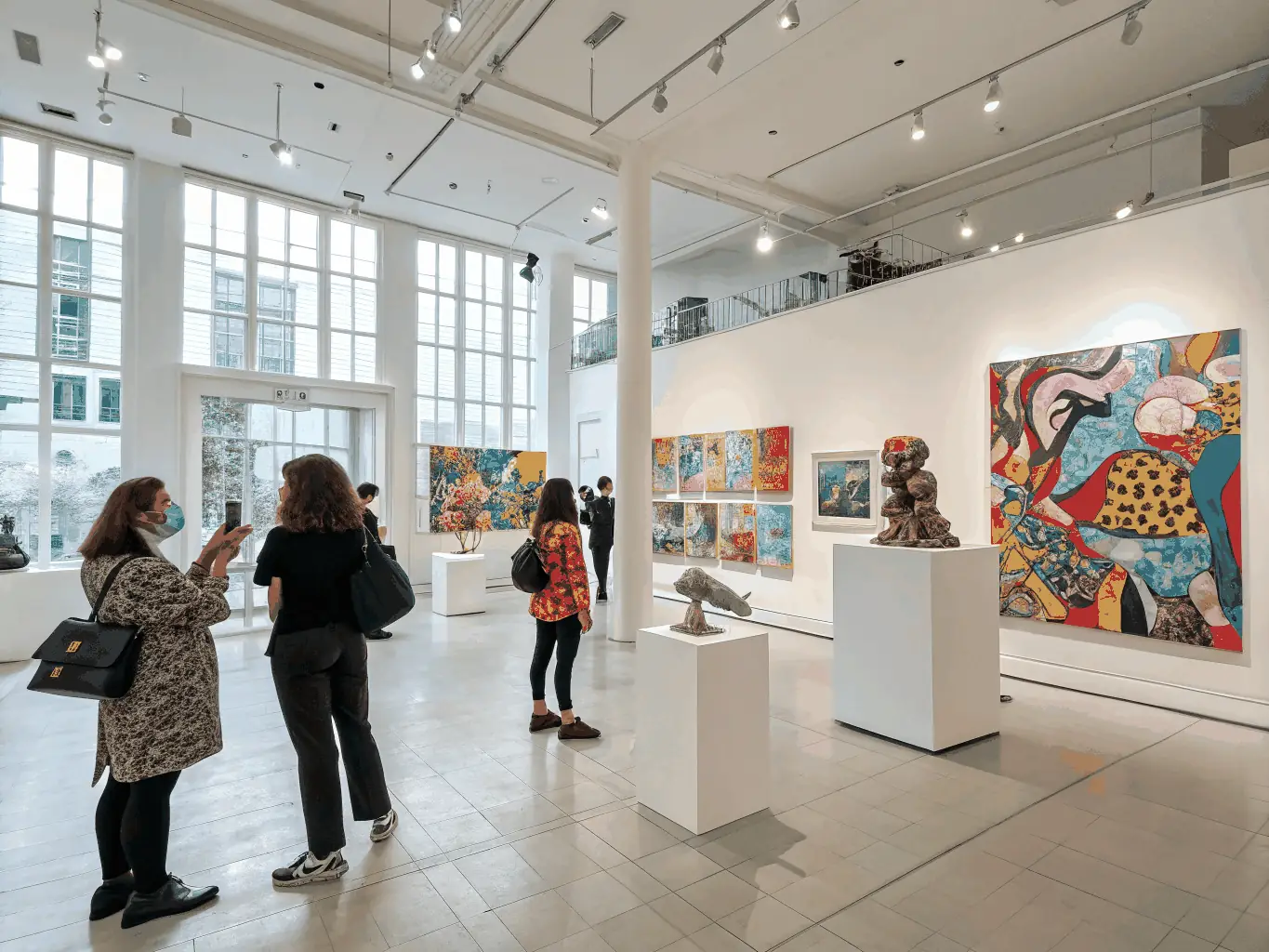 A photograph showcasing a community art exhibition organized by LUMIERE ANTIQUE, featuring artwork created by local artists and community members.